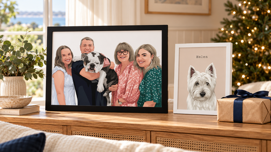 Framed family and pet portraits beside a wrapped Christmas gift in a sunlit home.