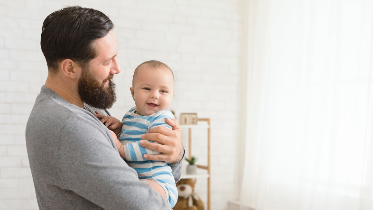 Father sharing a special moment with his baby, celebrating Father's Day with a personalised gift